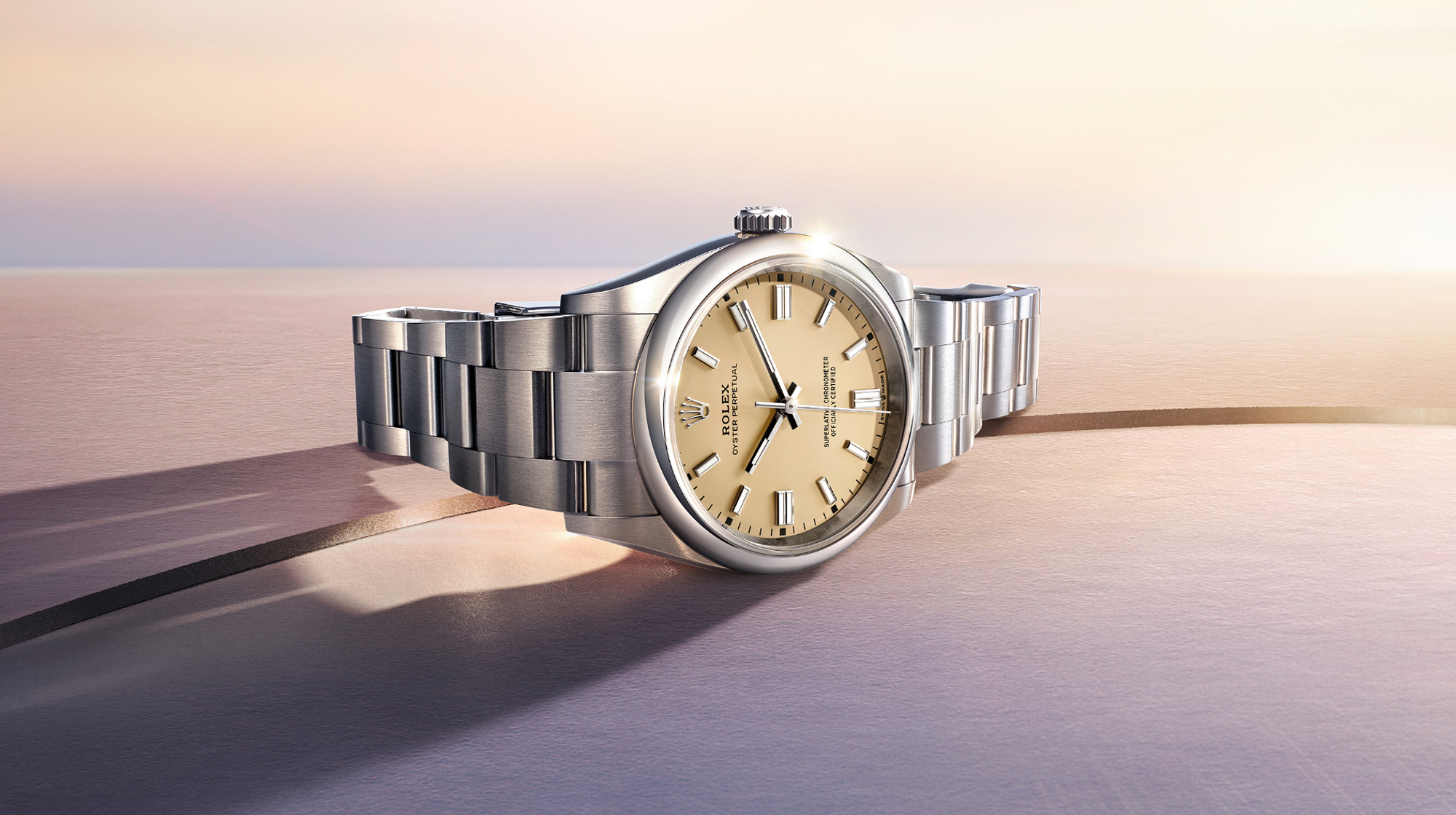 Two luxury wristwatches, each with a diamond-encrusted bezel and three subdials. The left watch has a black strap, and the right watch has a silver metal bracelet. Both display the name Rolex.